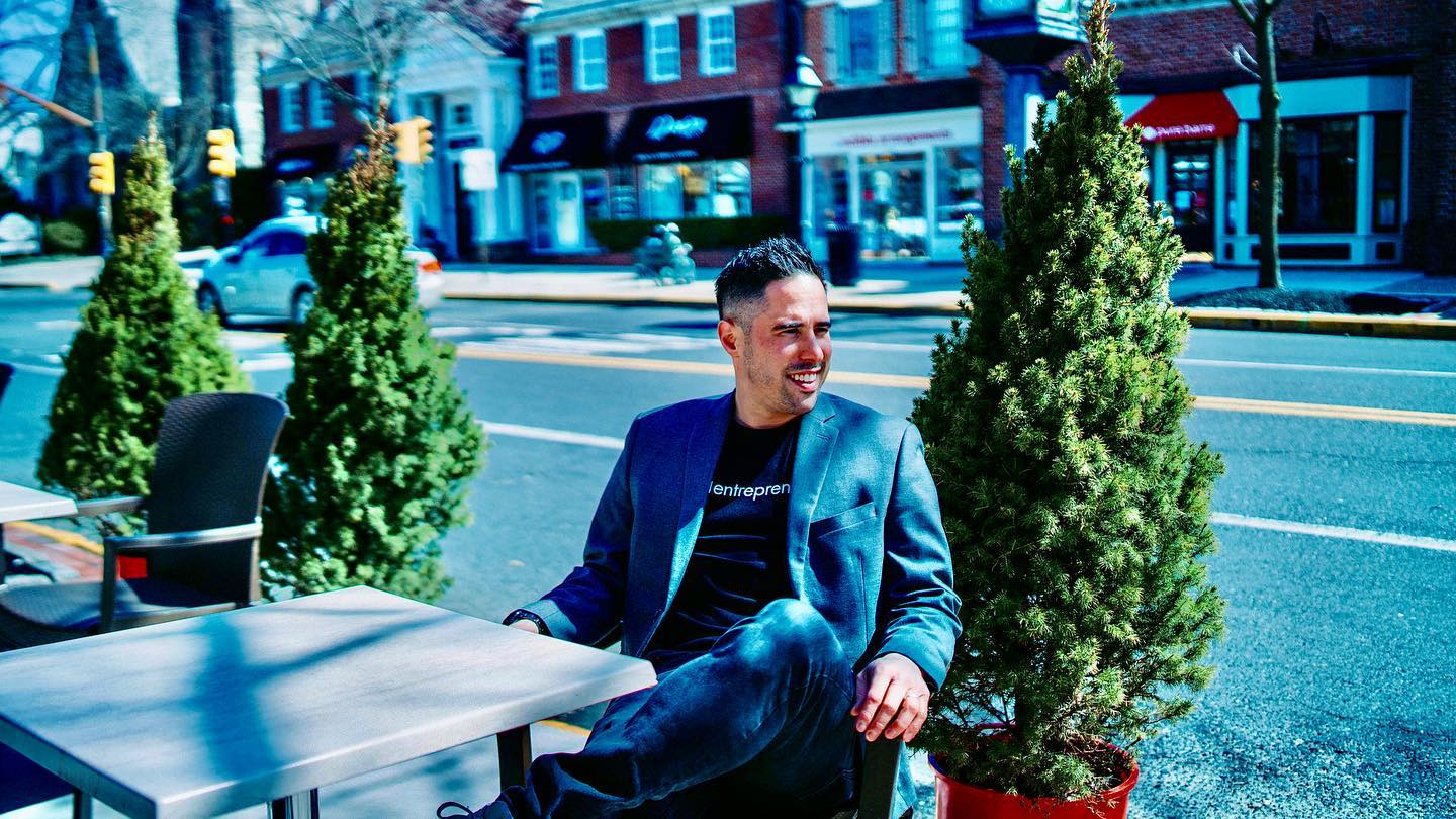 Matthew Auterson at a sidewalk table downtown